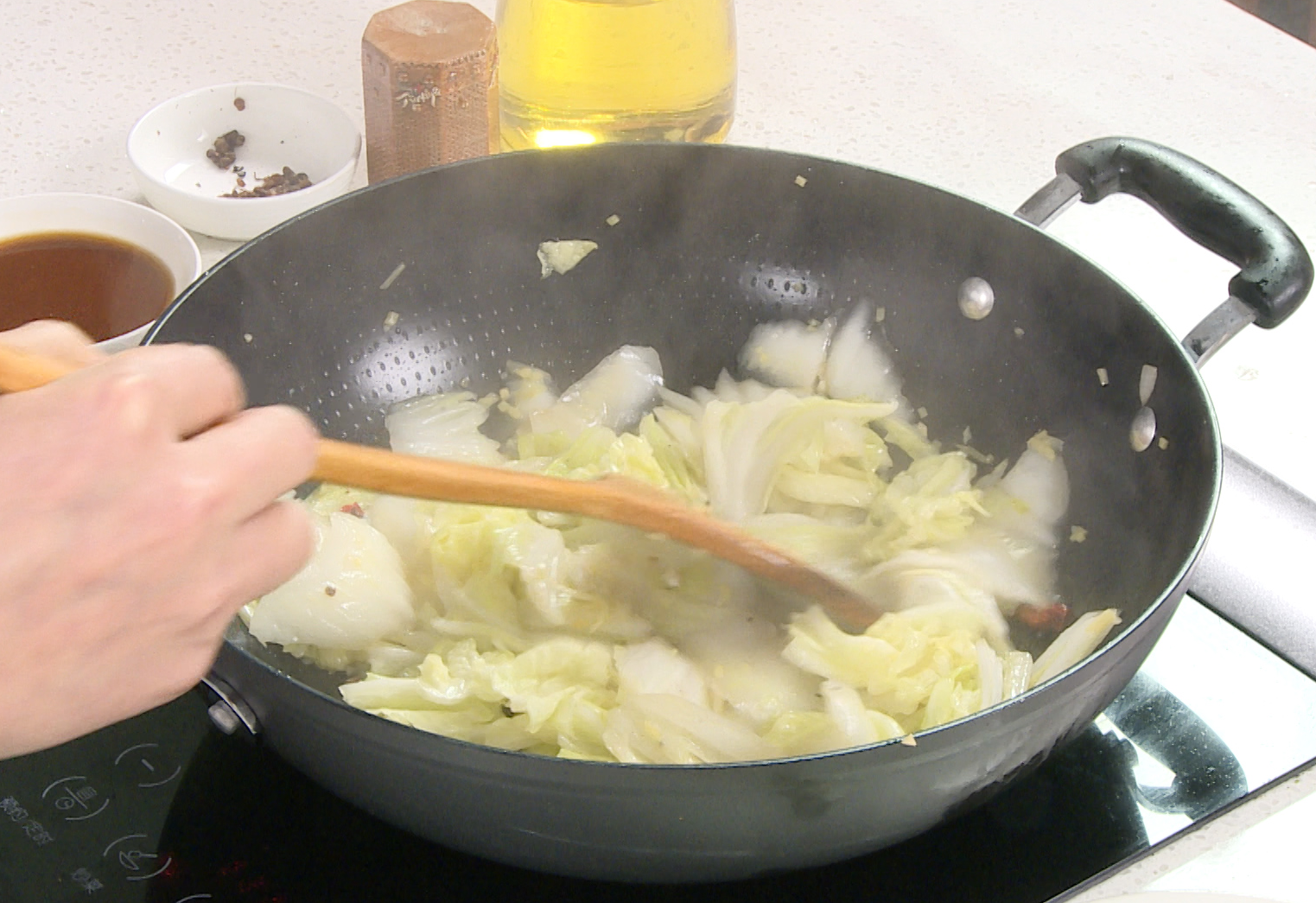 Instructions for stir-frying Napa cabbage until tender and slightly wilted.