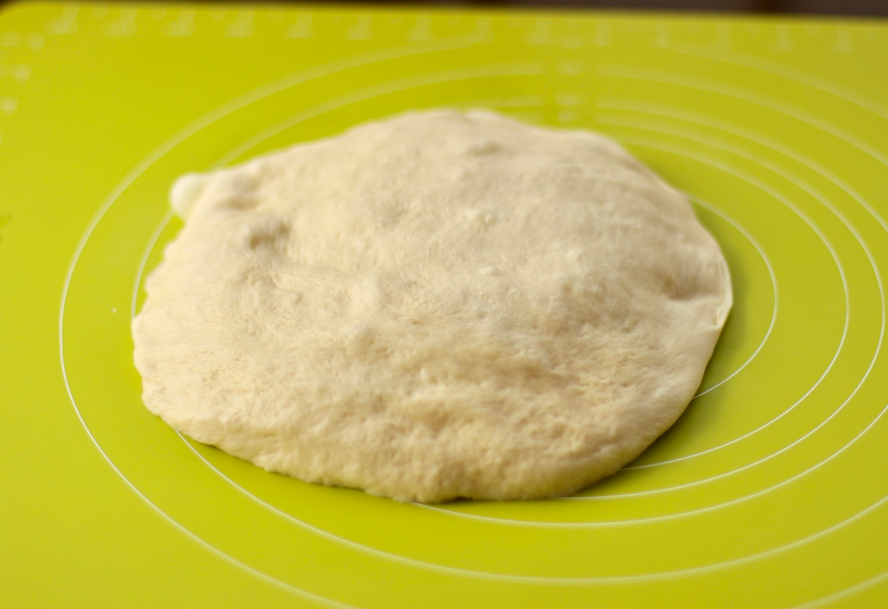 Knead and press dough to release trapped air bubbles.