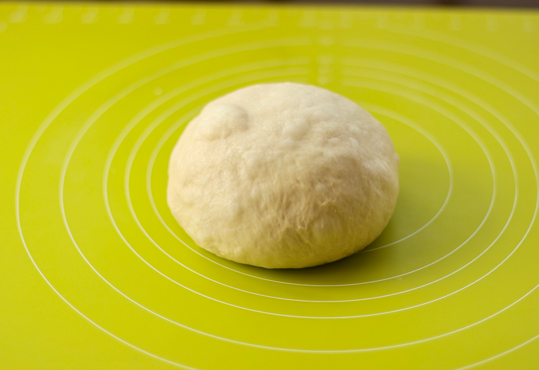 Shape dough into round ball after folding.