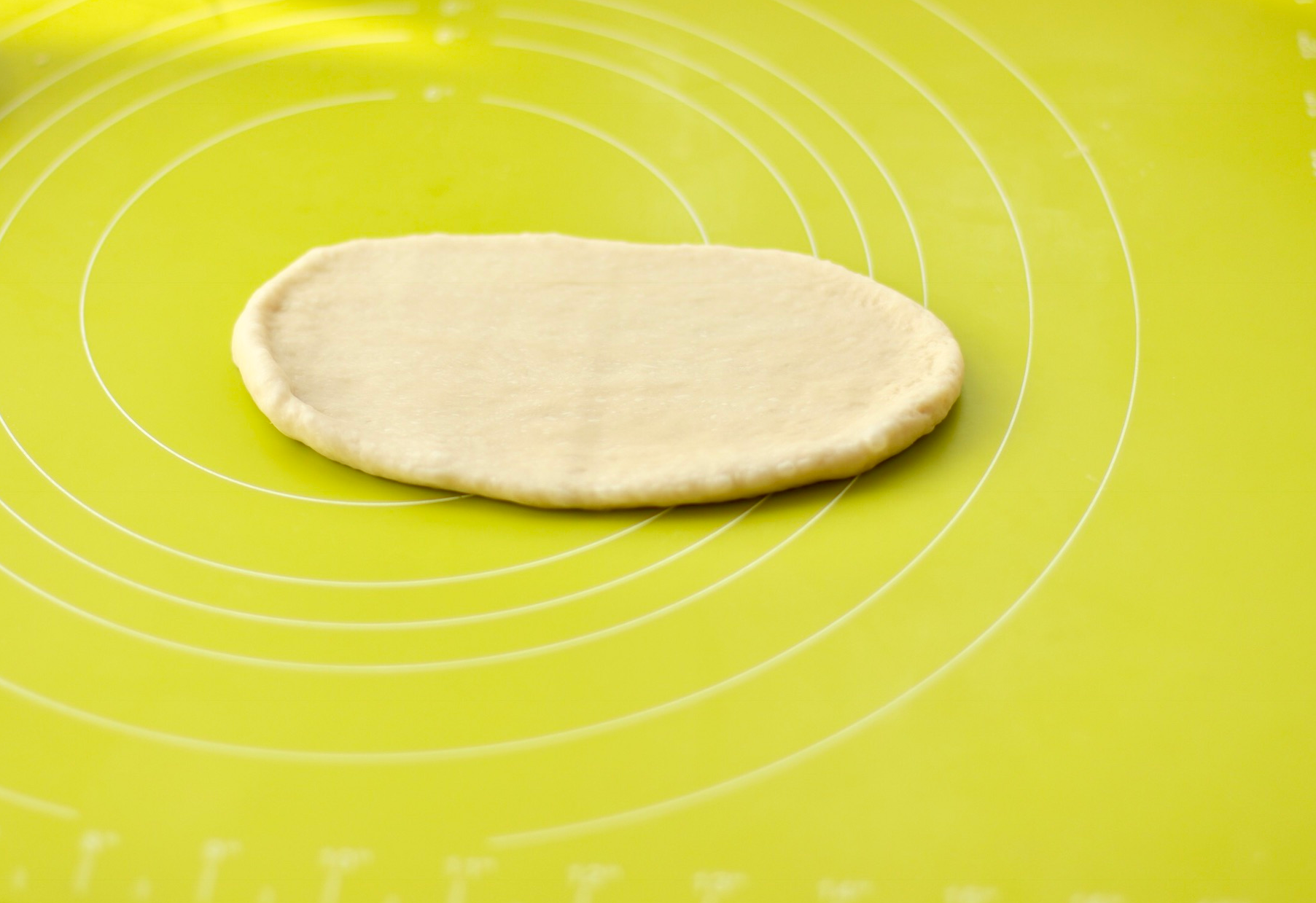 Shape the rolled dough into a long, tongue-like strip.