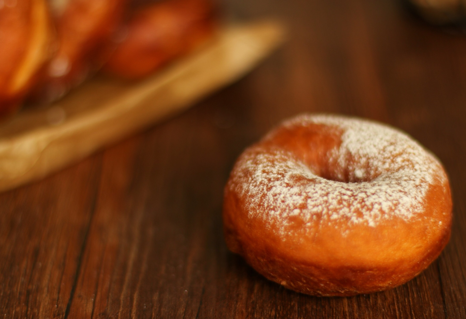 Sprinkle powdered sugar over the donuts for final touch.