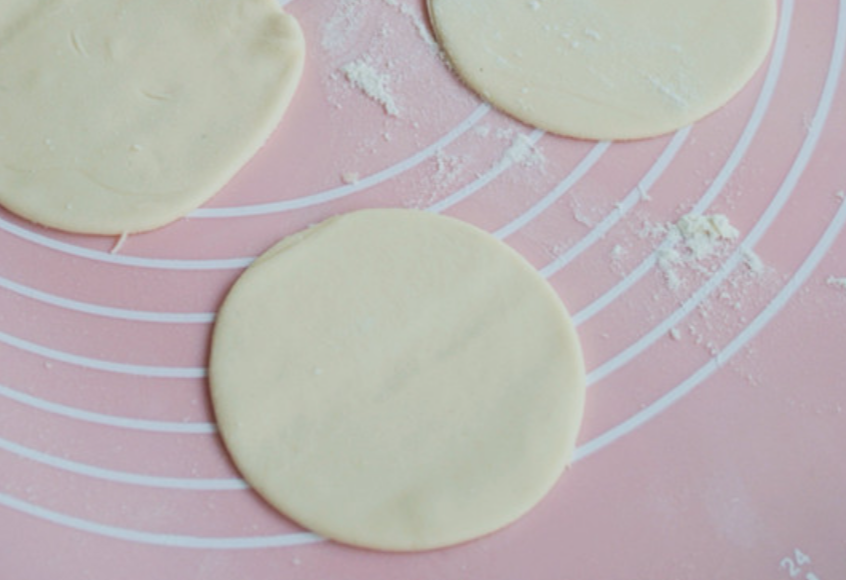 Roll, cut, flatten dough. Use cup or cutter for circular dumpling wrappers. For guide, see previous tutorial.