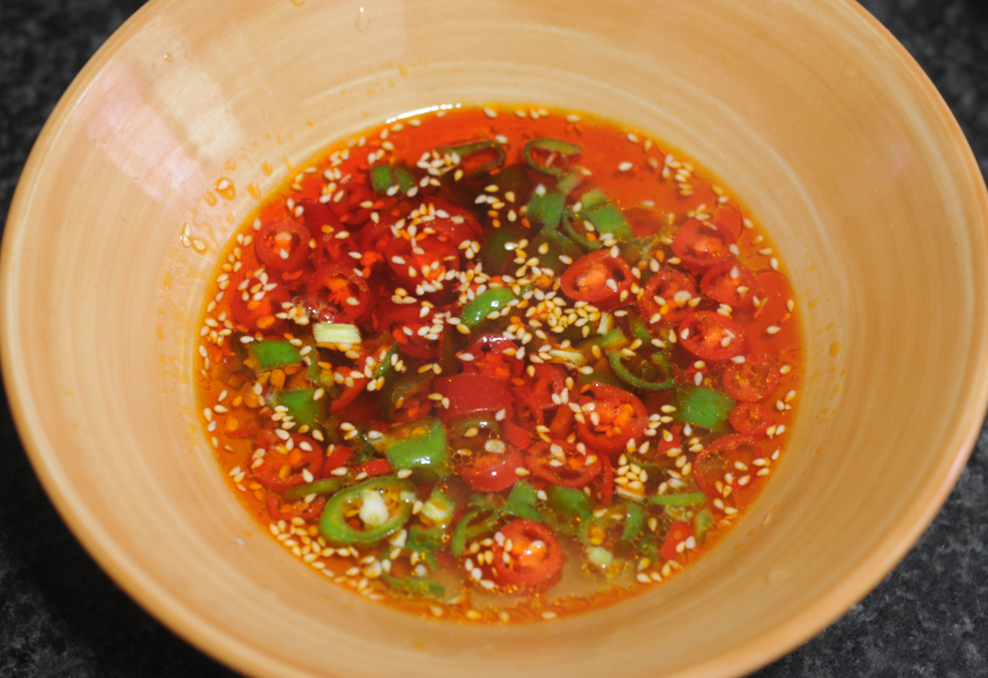 Make a sour and spicy broth with chopped peppers, spices, and boiling water.