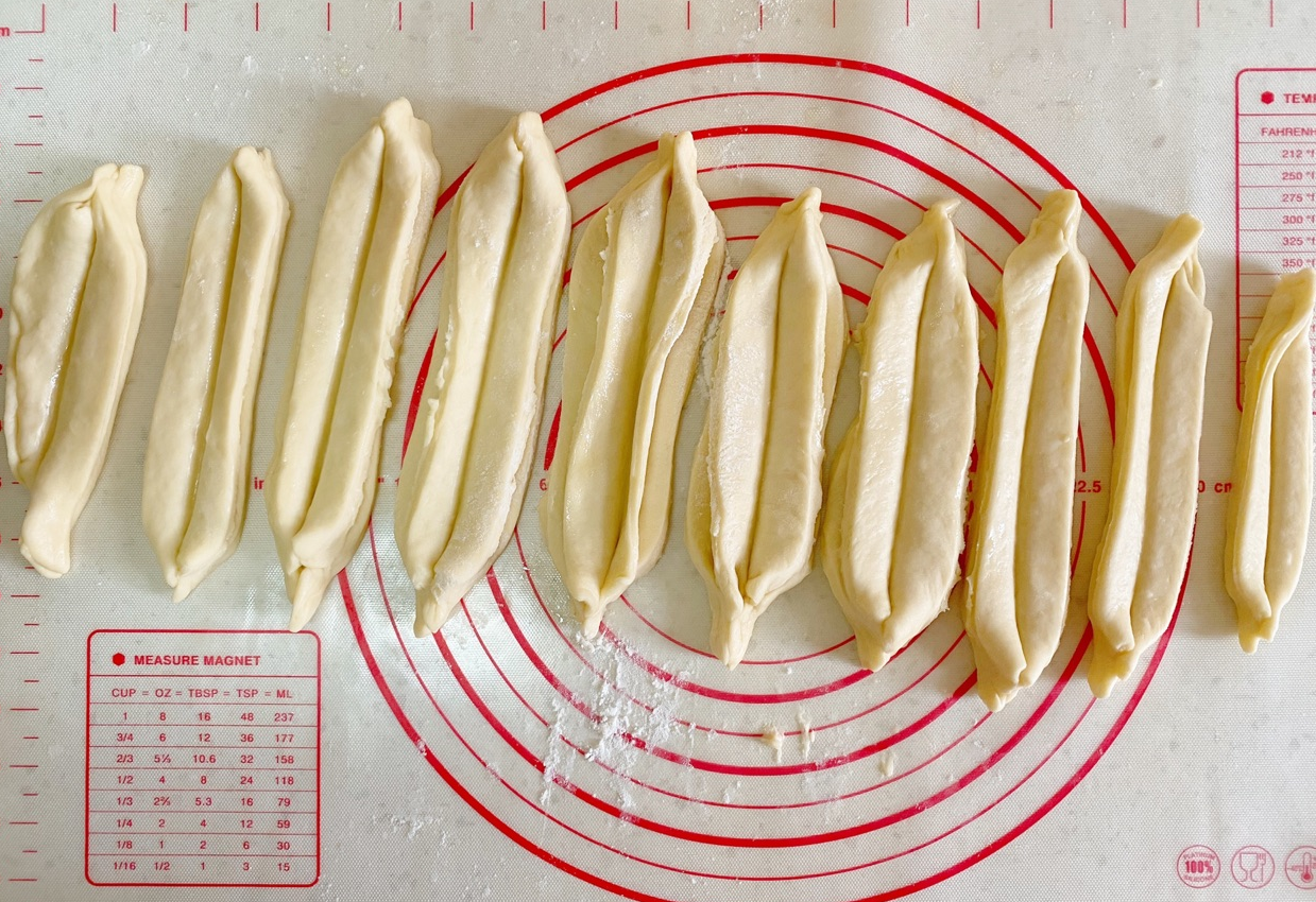 Instructions for shaping donut sticks: Stack strips, press middle, pinch ends.