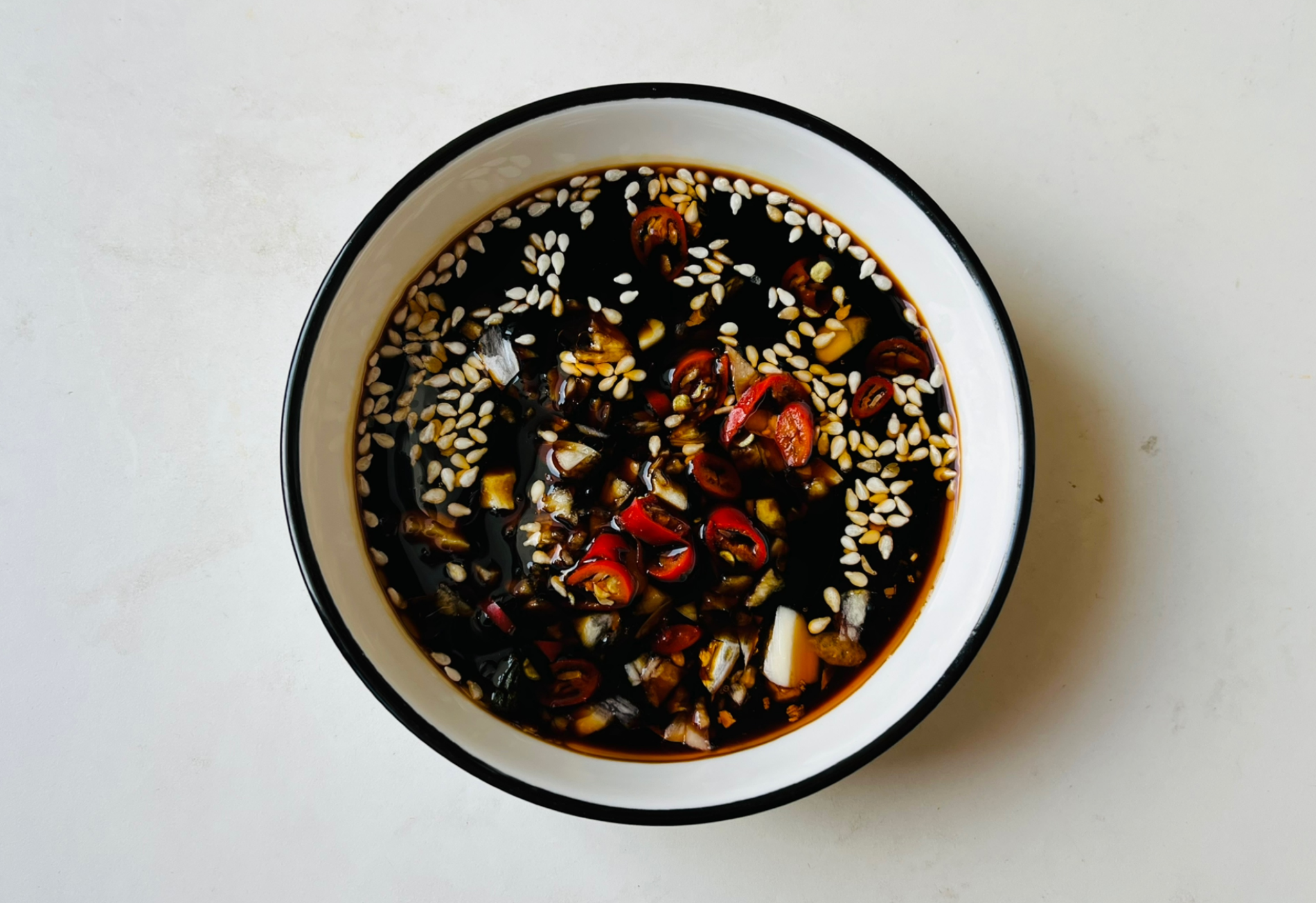 Recipe for a flavorful seasoning sauce with soy sauce, vinegar, sugar, bouillon, sesame seeds, oyster sauce.