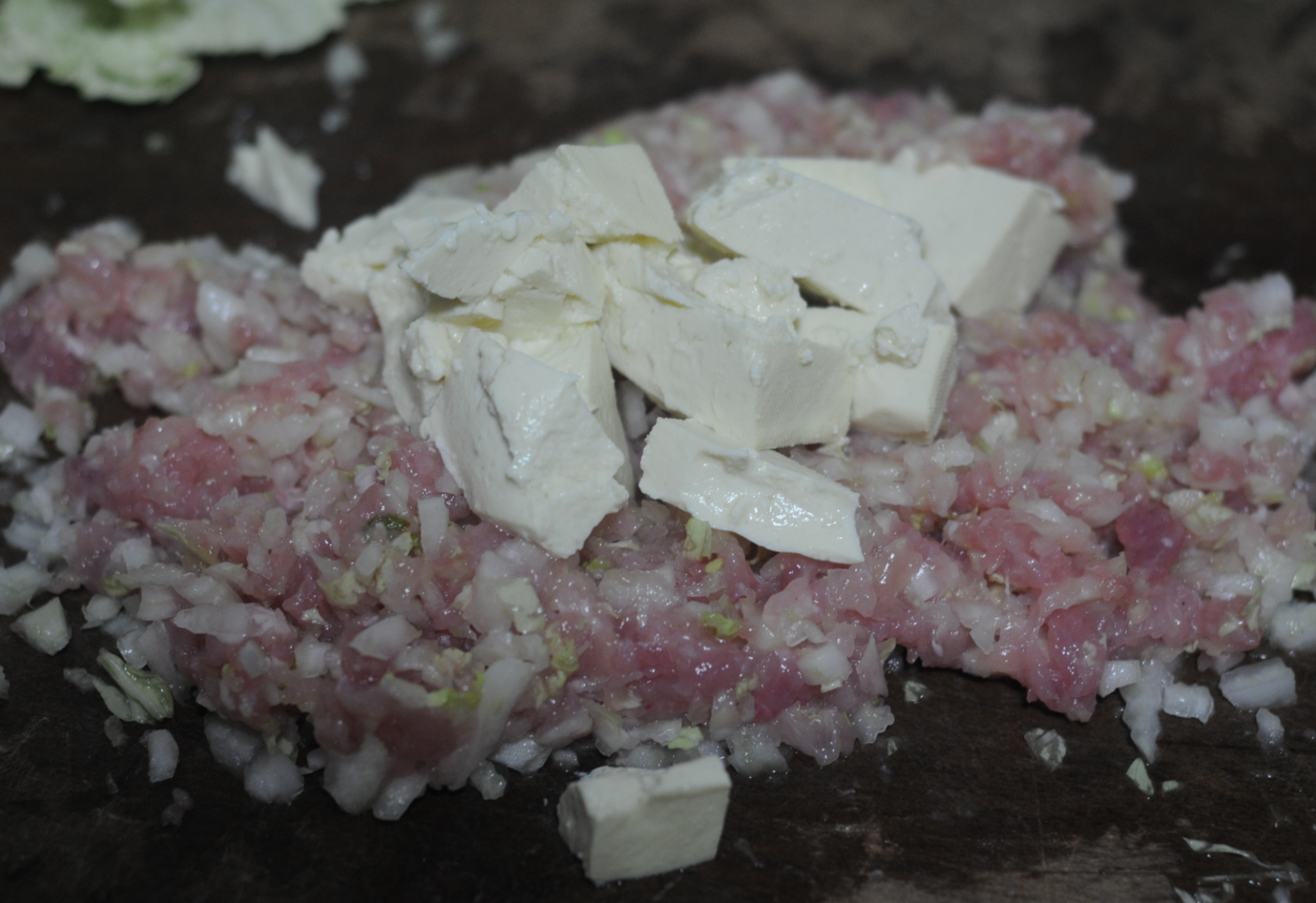 Prepare pork and cabbage filling with tofu for dumplings.