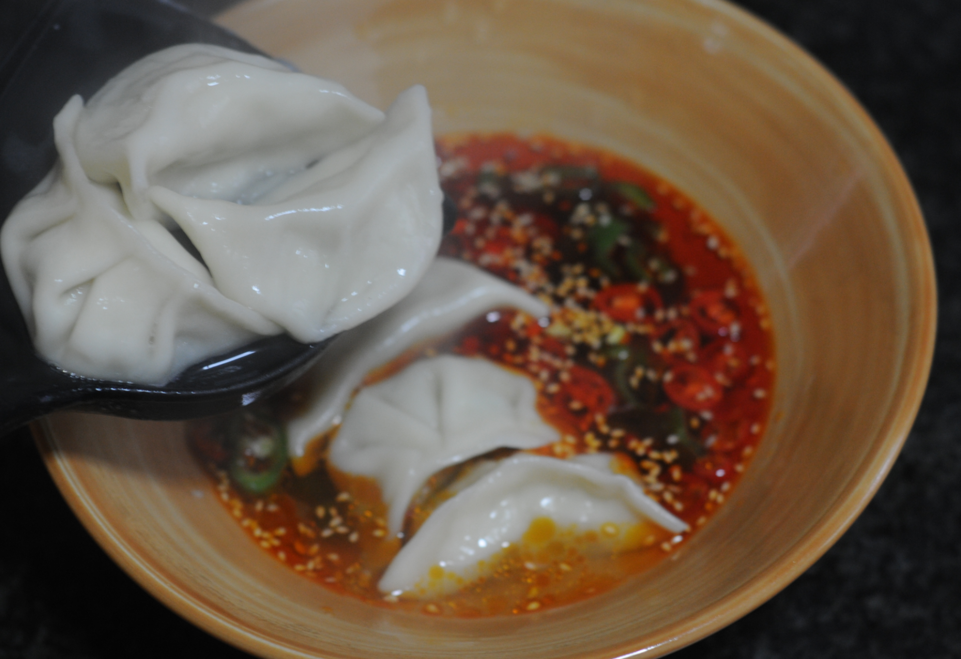 Transfer cooked dumplings to soup bowl for serving.