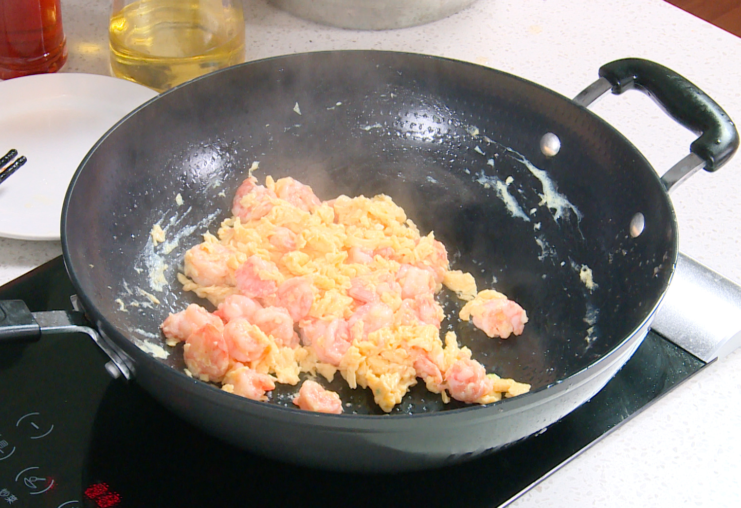 Cook eggs with shrimp in pan, ensuring eggs are partially set before adding shrimp to coat. Serve. Avoid overcooking eggs.