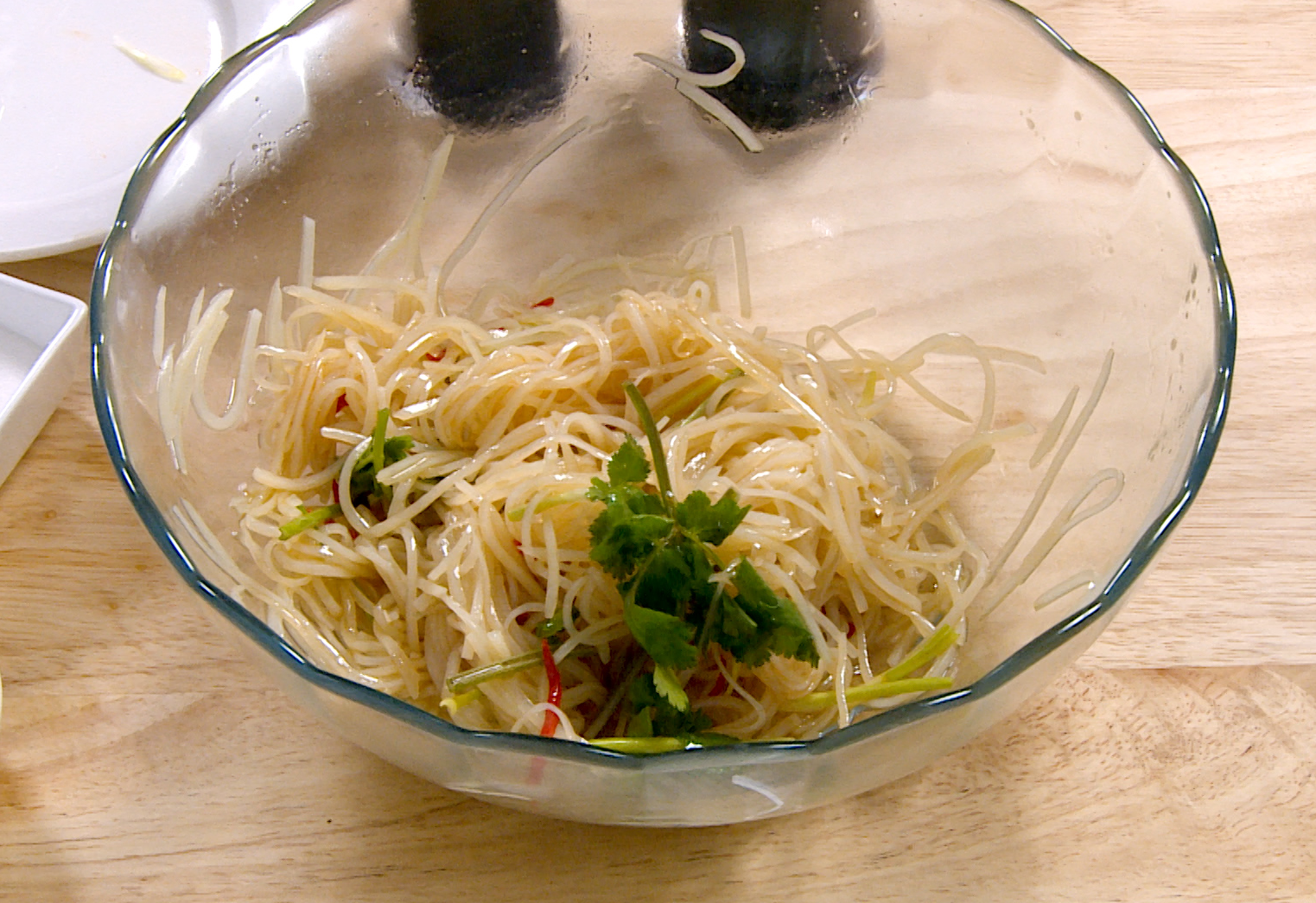 Mix potato strips, red pepper, cilantro, green onion in vinegar, soy sauce, chili oil for salad.