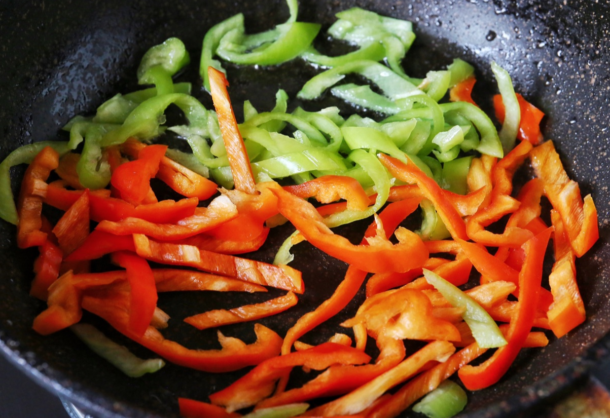 Cook red and Serrano peppers in sausage oil.