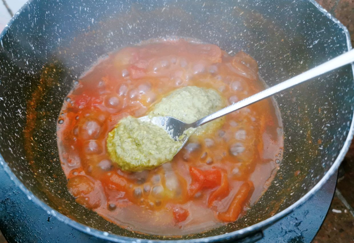 Season simmering sauce with basil, salt, and pepper; let simmer.