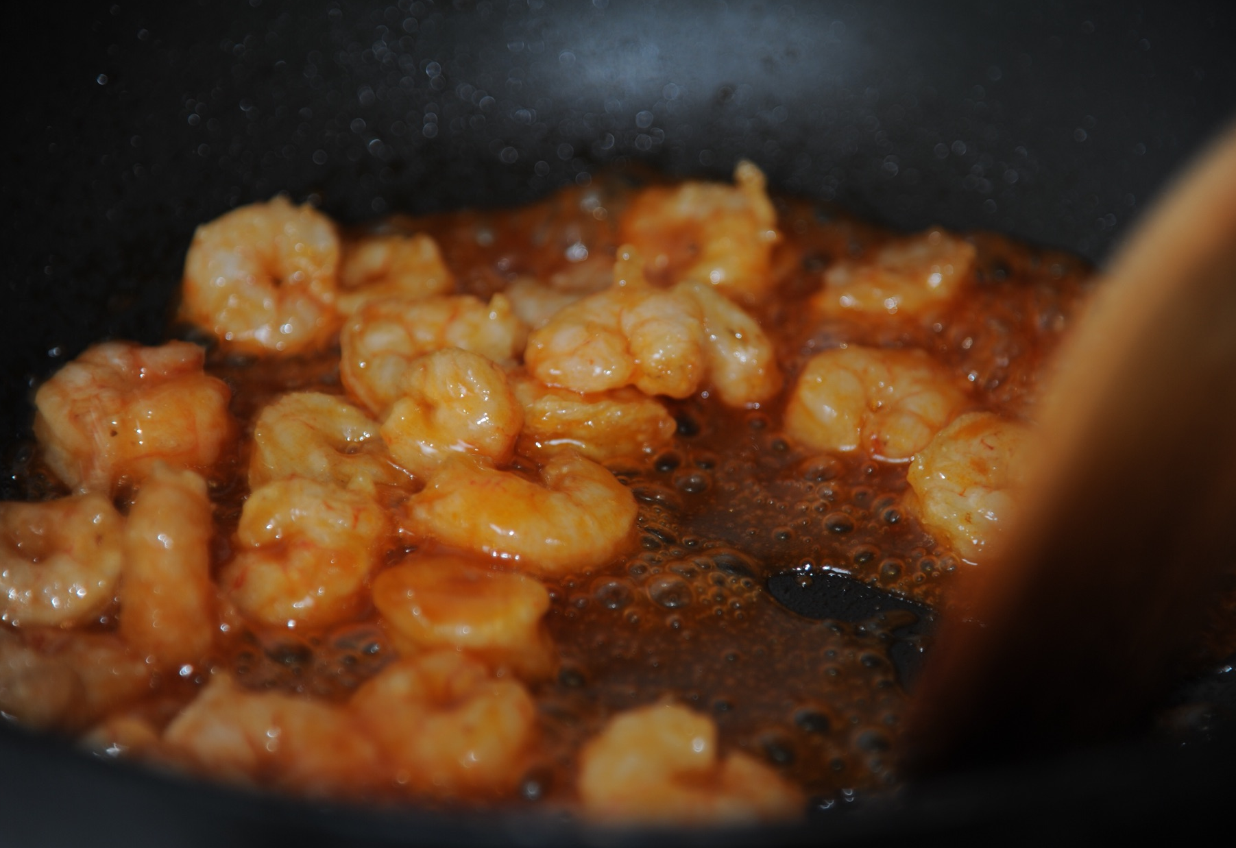 Coat shrimp evenly, reduce sauce.