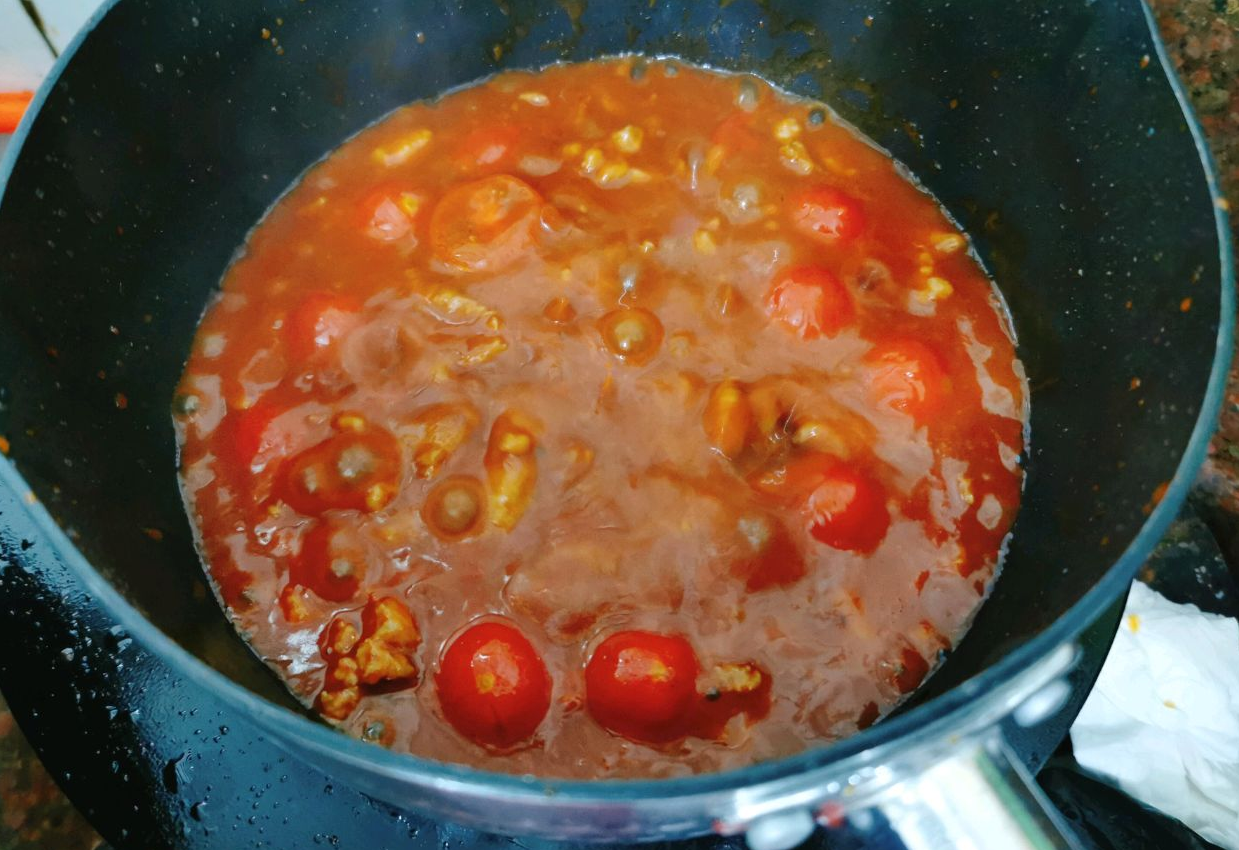 Make cherry tomato sauce: Sauté cherry tomatoes, water, and tomato sauce until broken down.