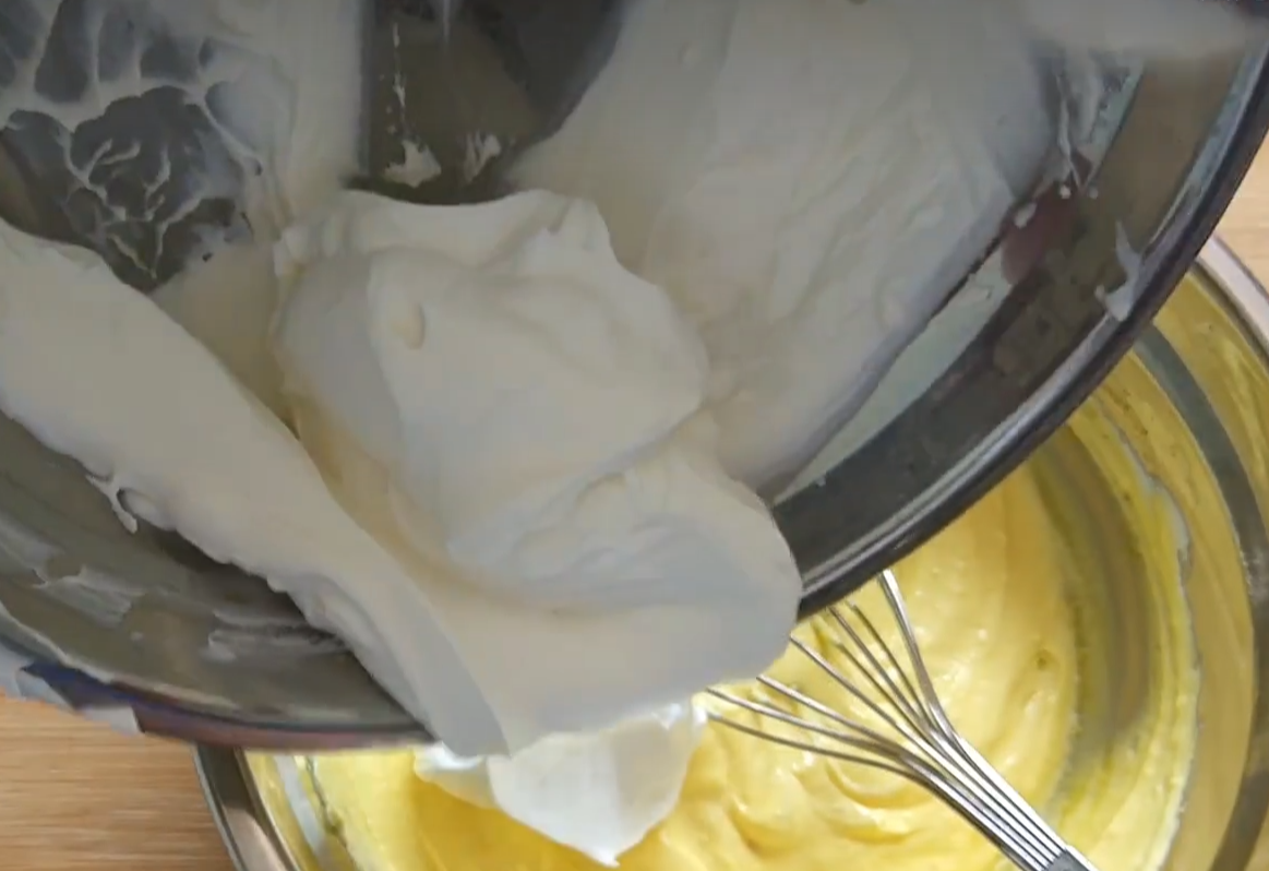 Fold whipped cream into mixture for even consistency.