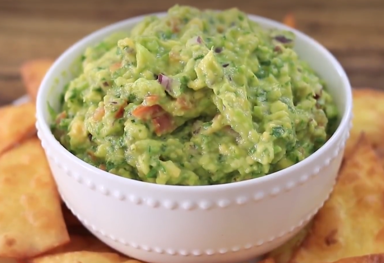 Delicious guacamole ready to enjoy with tortilla chips.