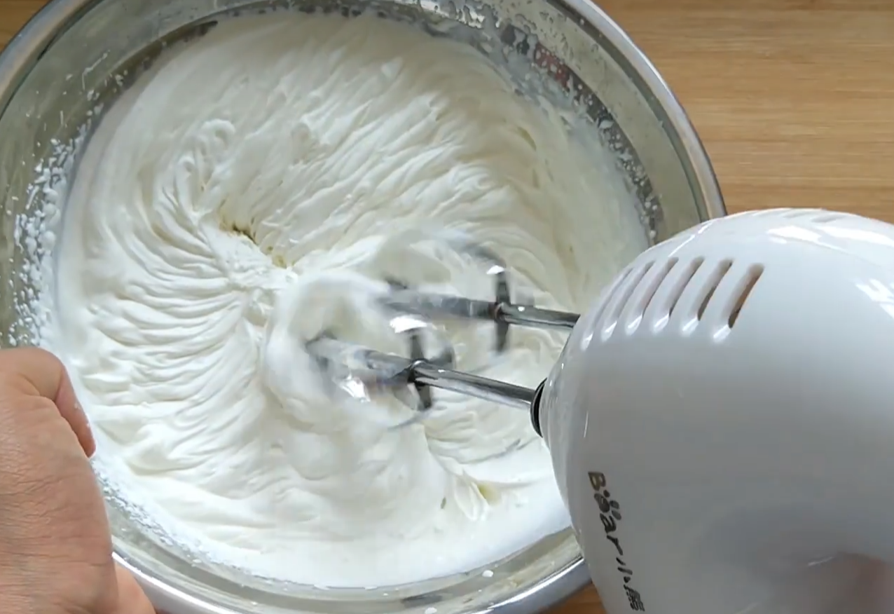 Whip cream until peaks form and it's smooth.