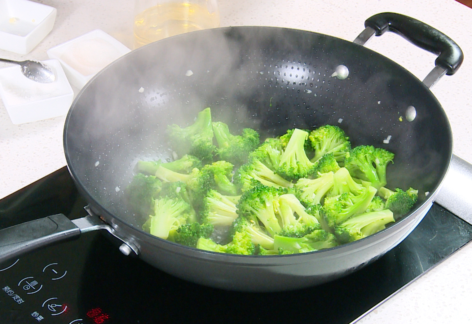 Stir-frying broccoli with garlic, salt, and sugar for a quick and flavorful dish.