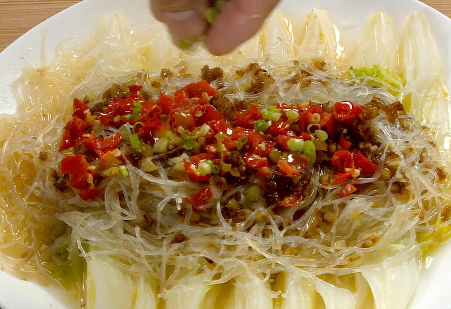 Enhance flavor with hot oil pour after steaming glass noodles and baby bok choy.