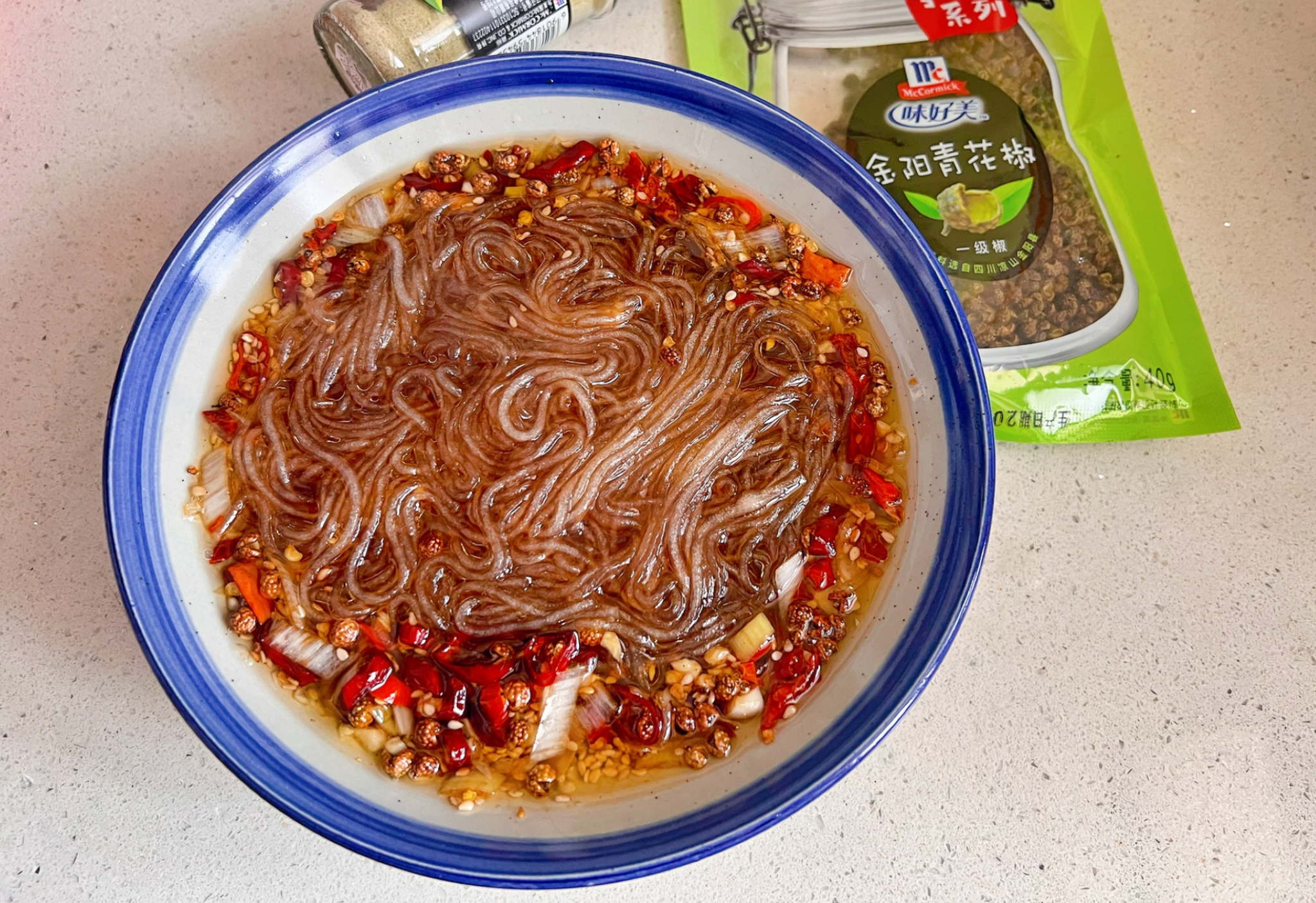 Instructions to combine cooked noodles with seasonings in a bowl.