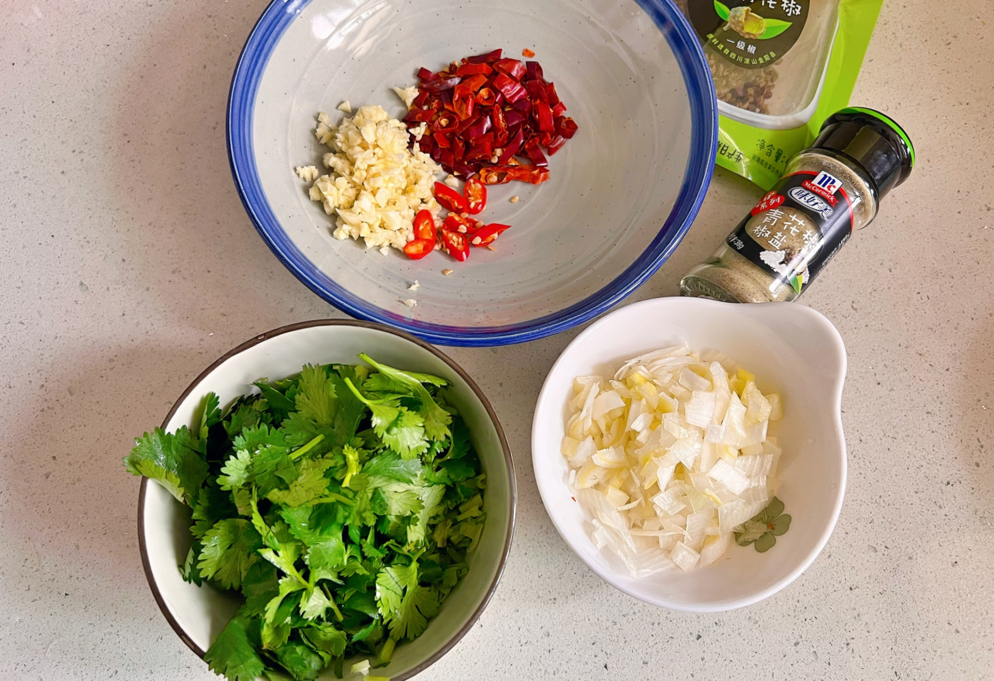 Chop garlic, Thai chili peppers, scallions, and cilantro finely.