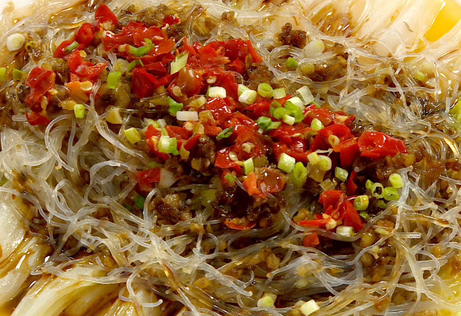 Enhance dish with steamed fish soy sauce for savory umami flavor. Add green onions for freshness.