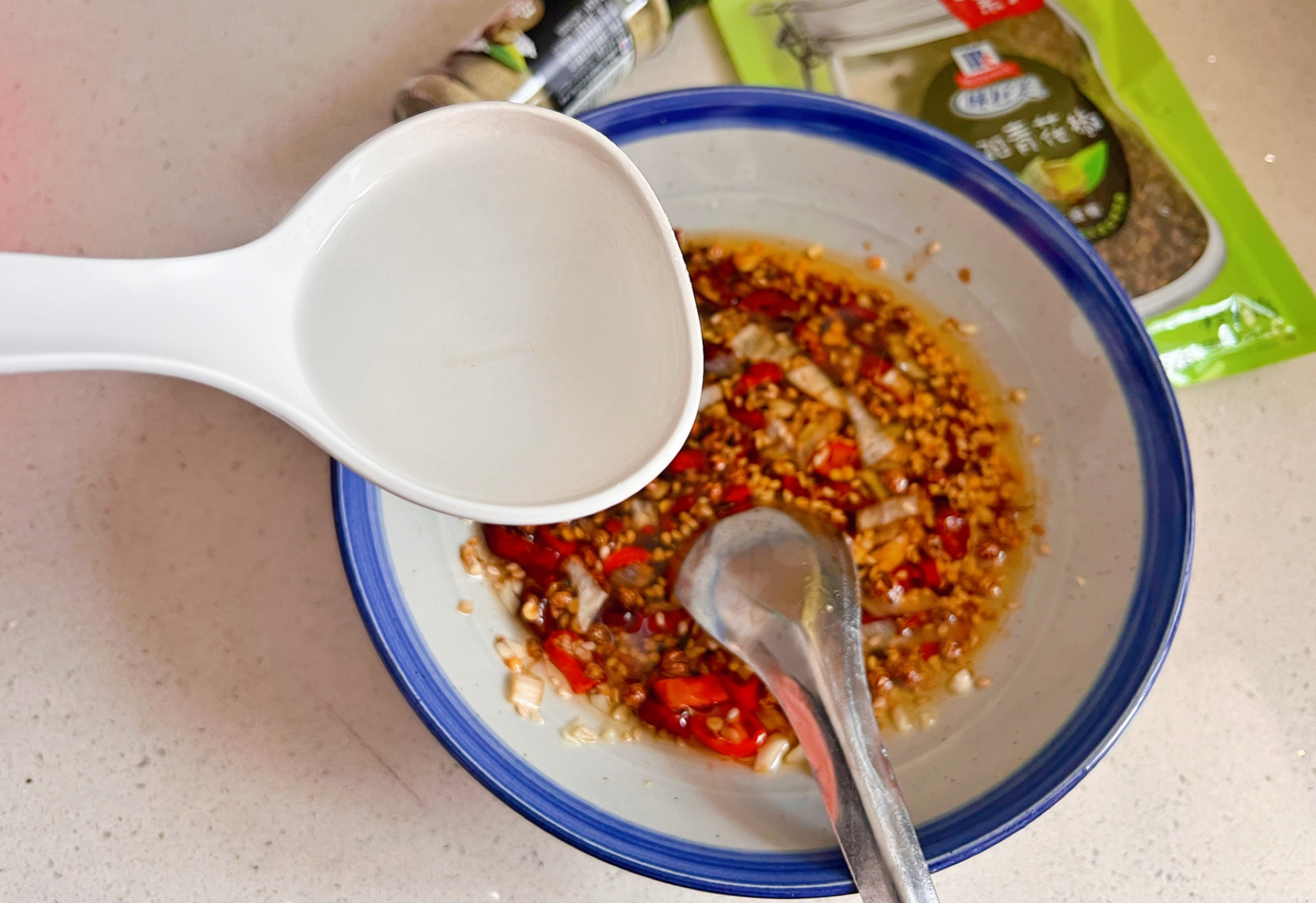 Add 2 tablespoons of hot water to the seasoning bowl while noodles cook.