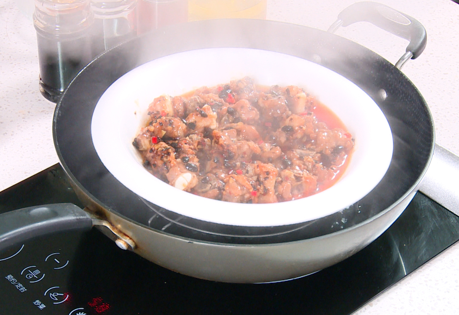 Steam ribs for 25 mins in a pot with water just below steamer. Add water if needed.