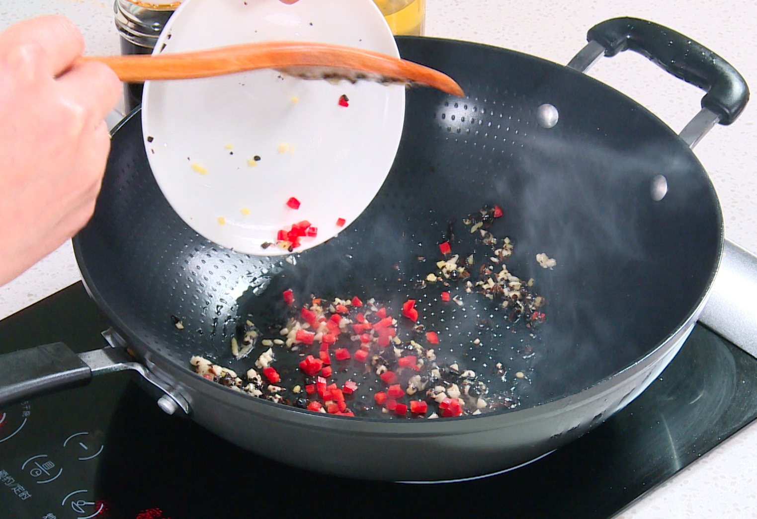 Stir-fry black beans, ginger, garlic, and chili pepper in oil for a flavorful sauce. Be careful not to burn garlic and ginger.