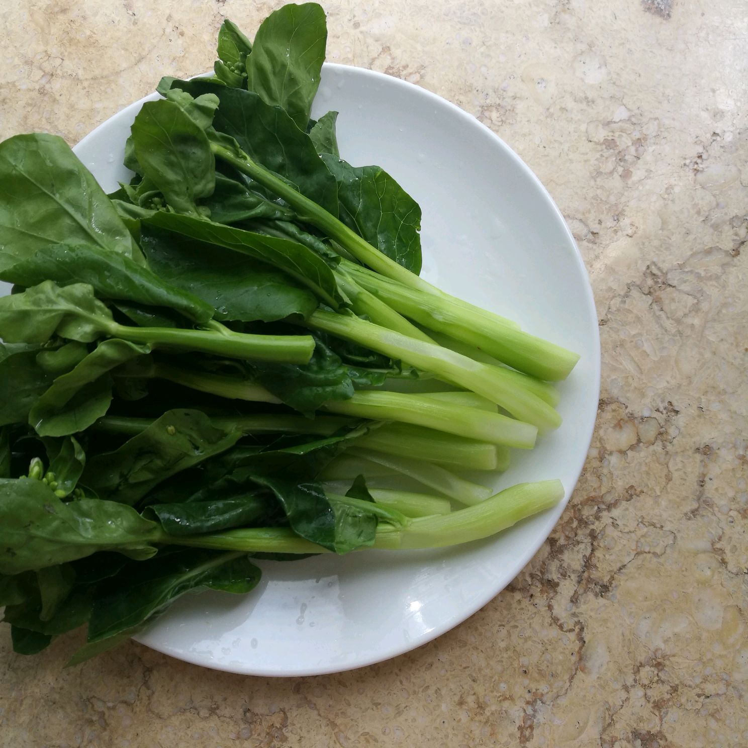 Trim and peel Kai-lan, rinse well for cooking.