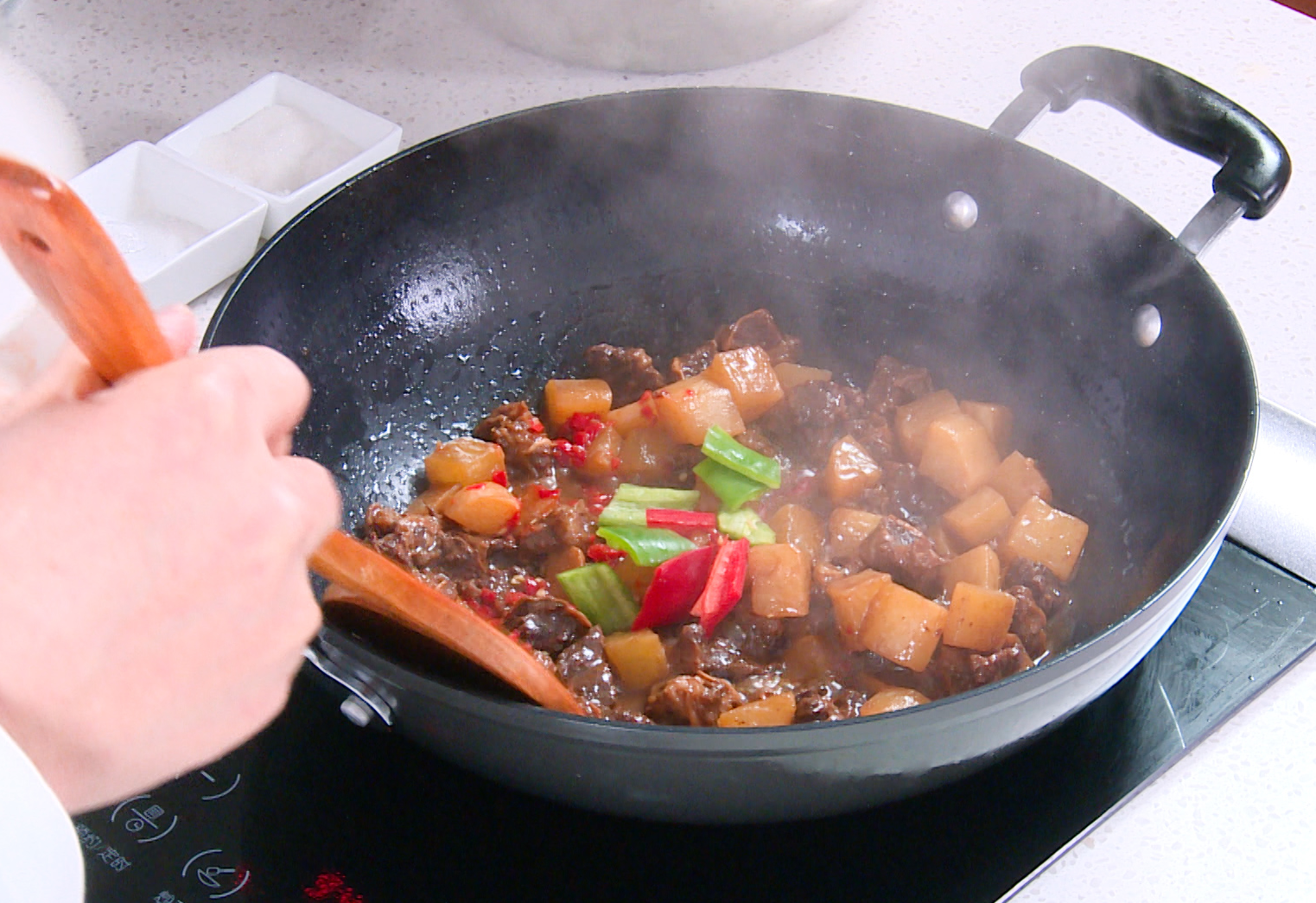 Add chili paste/hot sauce for heat, then green/red bell peppers. Cook 3-5 mins until peppers soften.