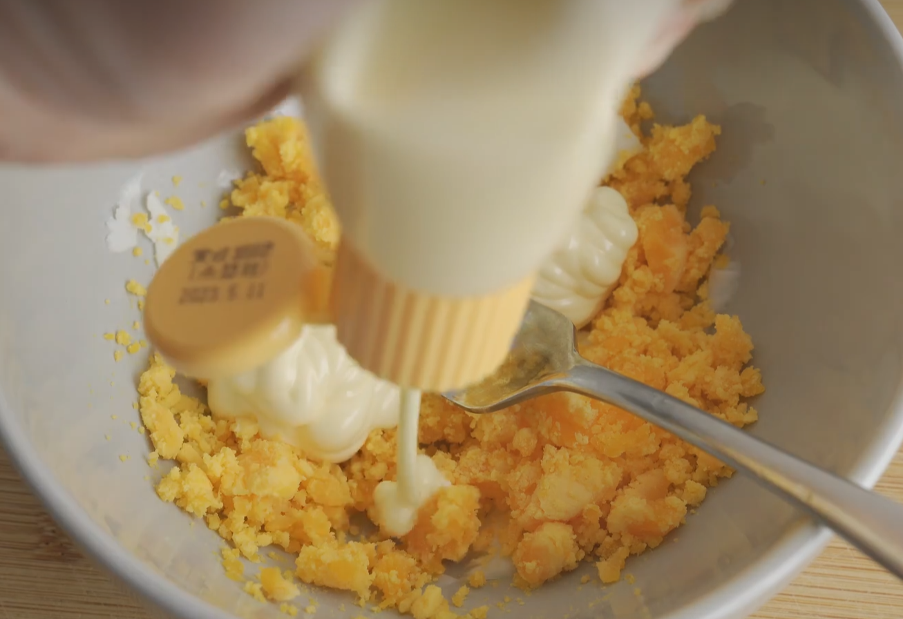 Combine mashed yolks with mayonnaise for a smooth mixture.