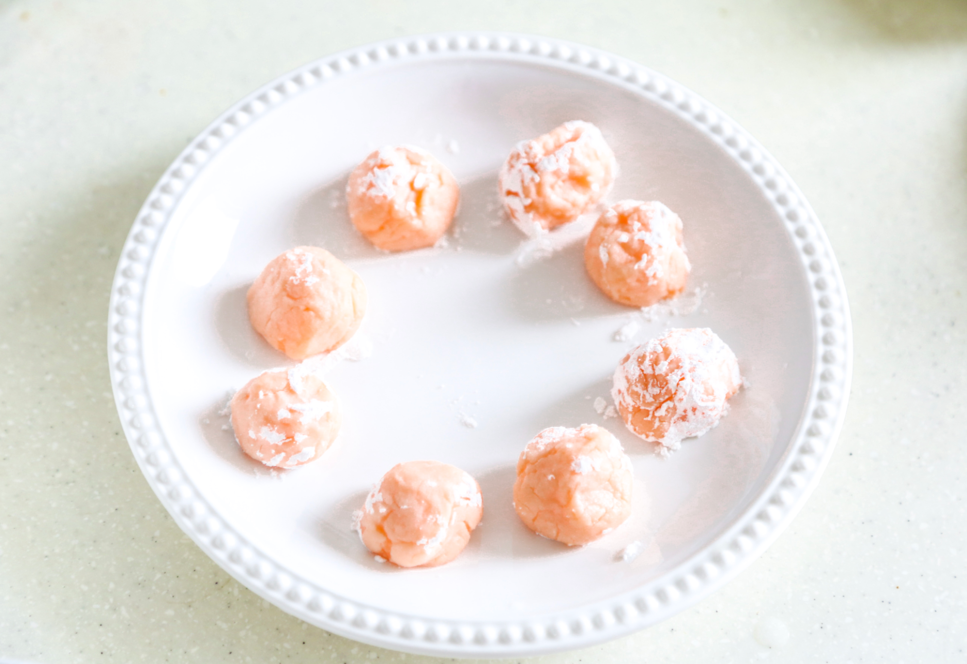 the coated salmon balls on a plate dusted with cornstarch.