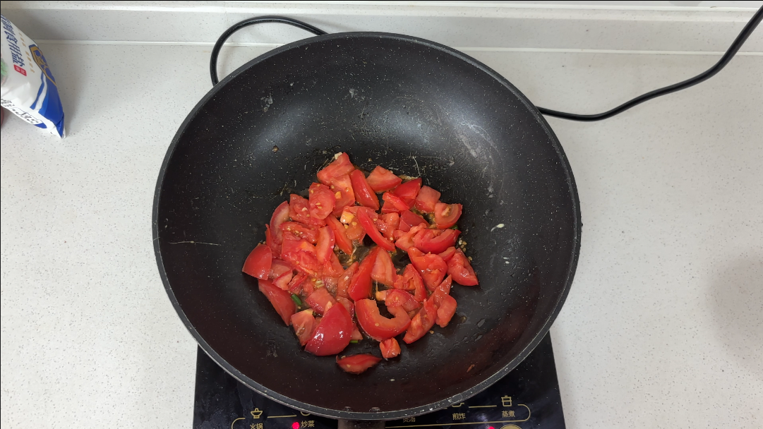 add the tomatoes to the pan and stir-fry