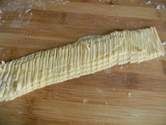 Fold the dough into a fan shape and cut it into thin strips