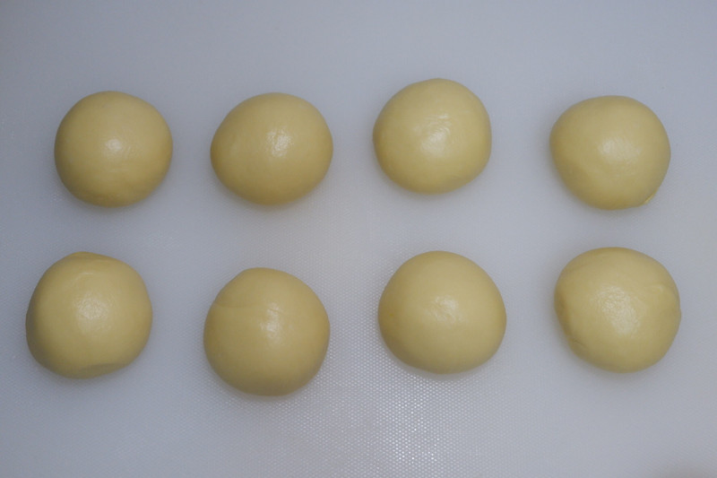 Divide the dough into 8 equal pieces and shape them into balls