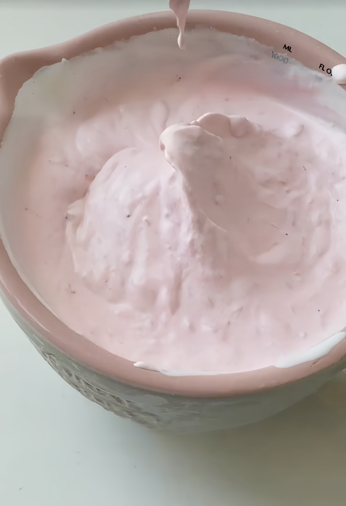 Mixing strawberry jam and light cream