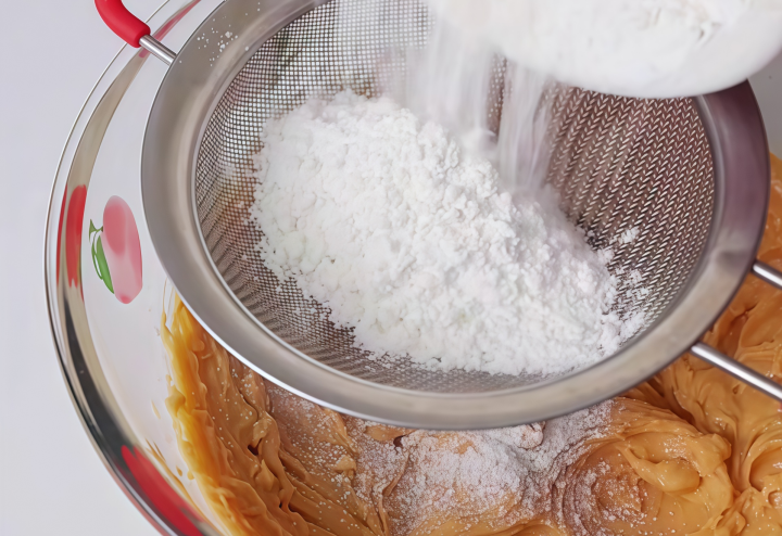 Sift in flour and stir to form dough