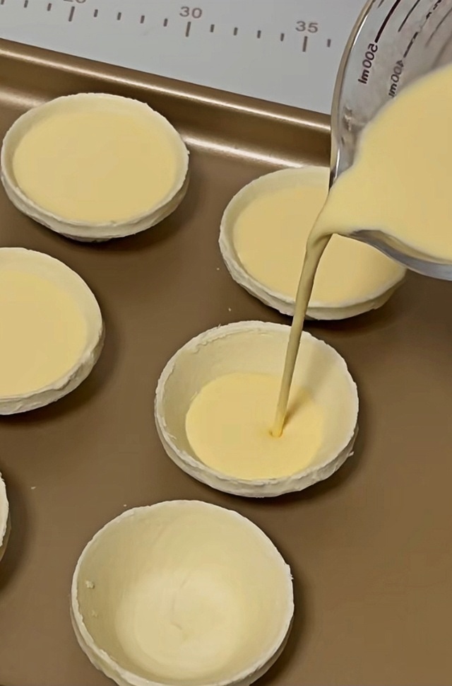 Pour the prepared custard into the tart shells